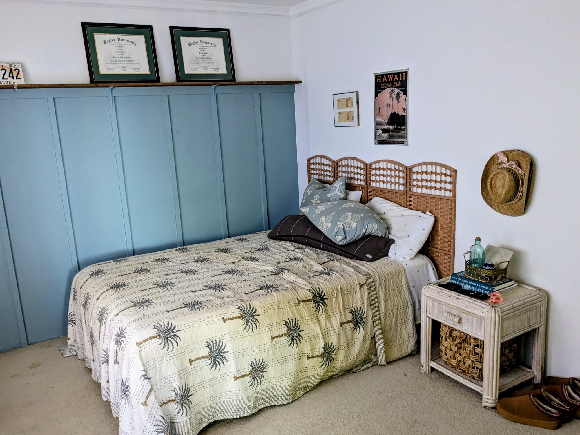 Bedroom with palm tree quilt and Hawaii poster