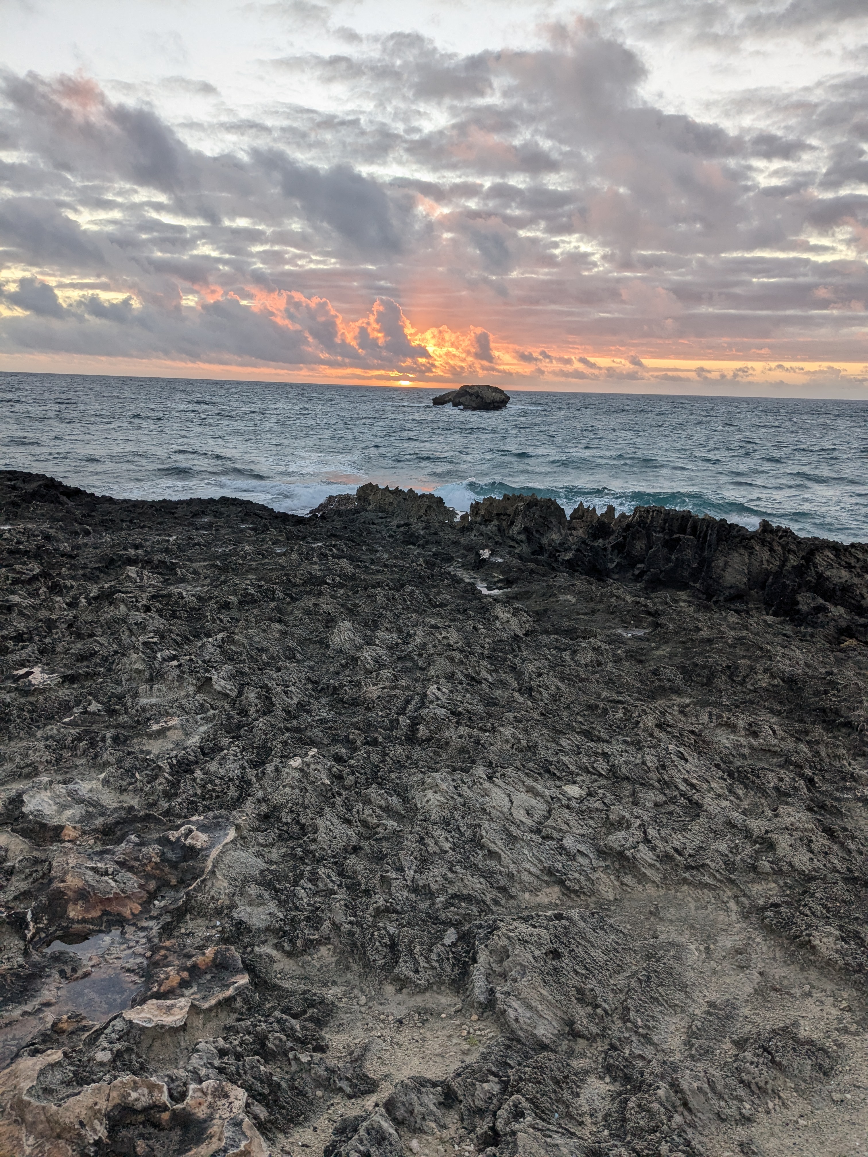 Sunrise over the sea arch islet at Laie Point
